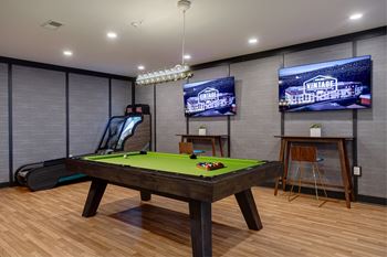 Lounge with retro arcade games, pool table, and ski ball